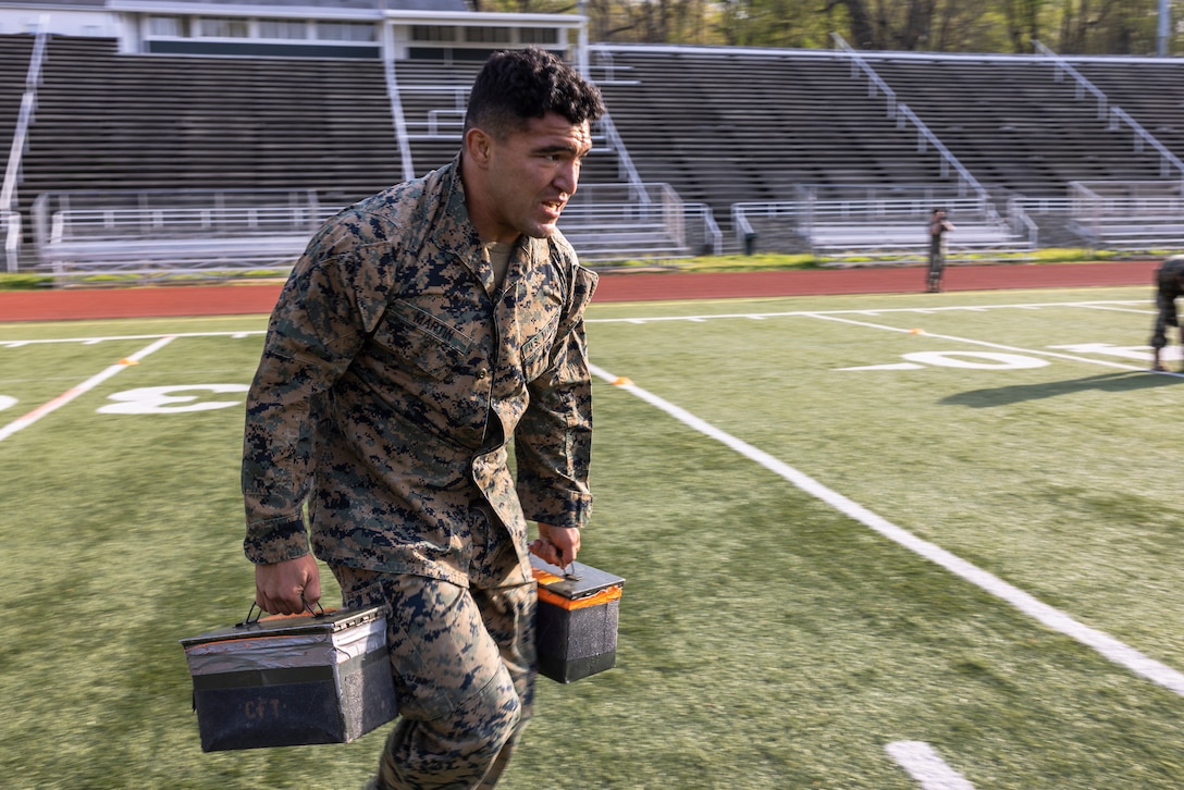 U.S. Marine Corps Sgt. Christopher Martin, an instructor with Naval Diving and Salvage Training Center, Panama City, Florida, runs with ammo cans as part of the first Training Education Command Fittest Instructor Competition on Marine Corps Base Quantico, Virginia, April 12, 2023. TECOM instructors are premier experts in their individual Military Occupational Specialty. A non-stop combat fitness test, also known as “Gas Can” is design to push even the fittest Marines to their limit.   (U.S. Marine Corps photo by James Frank)