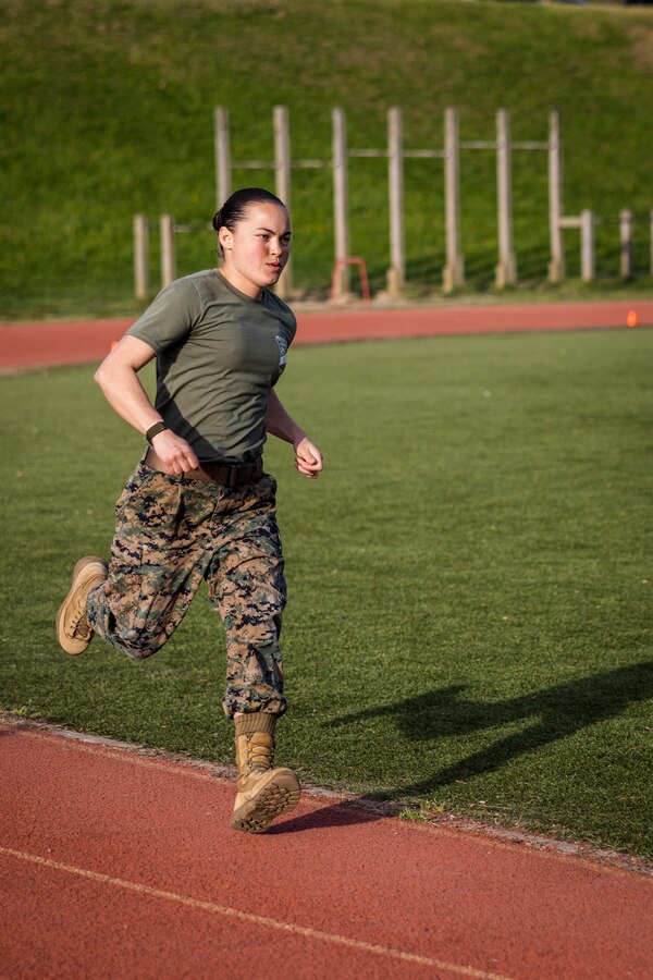 U.S. Marine Corps Capt. Hannah F. Montague, a physical training instructor at The Officer Candidates School, Virginia, runs during the maneuver to contact portion of the “Gas Can” event while participating in the first Training and Education Command Fittest Instructor Competition on Marine Corps Base Quantico, Virginia, April 12, 2023. The “Gas Can” event is a non-stop combat fitness test designed to push even the fittest Marines to their limit.   (U.S. Marine Corps photo by James Frank)