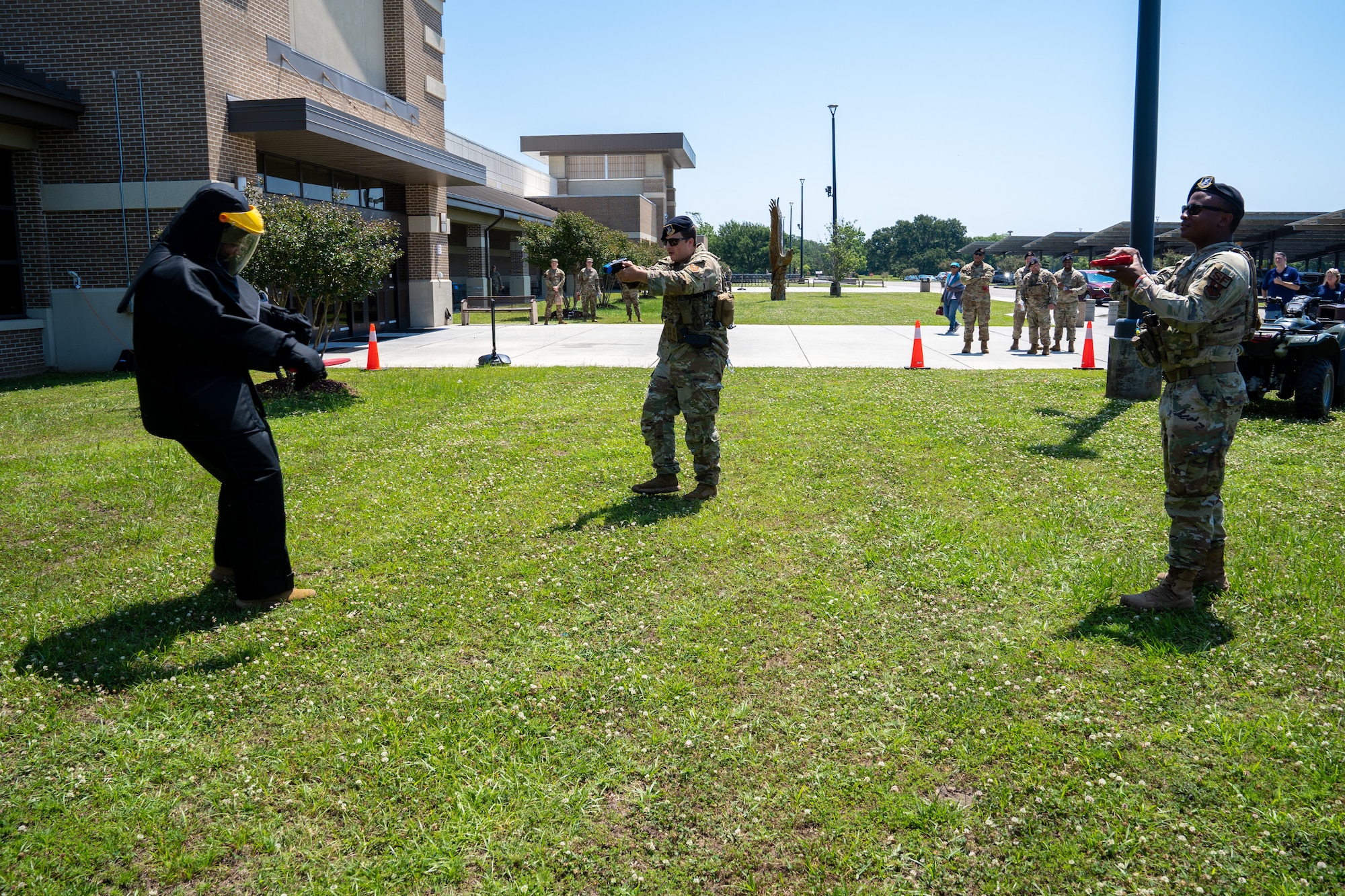 U.S. Air Force Staff Sgt. Jeffrey Wilson, 81st Security Forces Squadron flight sergeant, is tased by Staff Sgt. Brennan Bartos, 81st SFS base defense operator, while Senior Airman Tyler Barry, 81st SFS patrolman leader, provides security during a demonstration for National Police Week at Keesler Air Force Base, Mississippi, May 16, 2023.