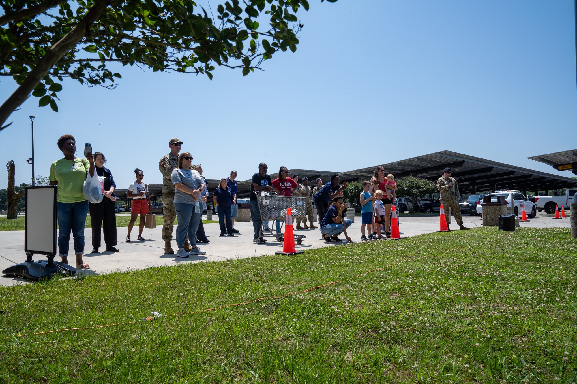 Airmen and civilians watch a military working dog demonstration for National Police Week at Keesler Air Force Base, Mississippi, May 16, 2023.