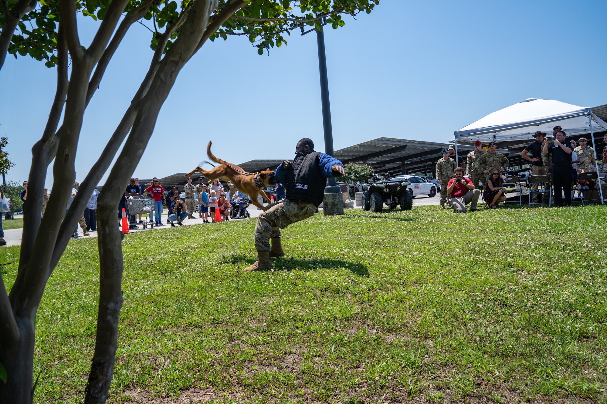 U.S. Air Force Senior Airman Victor Henderson, 81st Security Forces Squadron military working dog handler, demonstrates a takedown with Zzelle, 81 SFS military working dog, during a demonstration for National Police Week at Keesler Air Force Base, Mississippi, May 16, 2023.