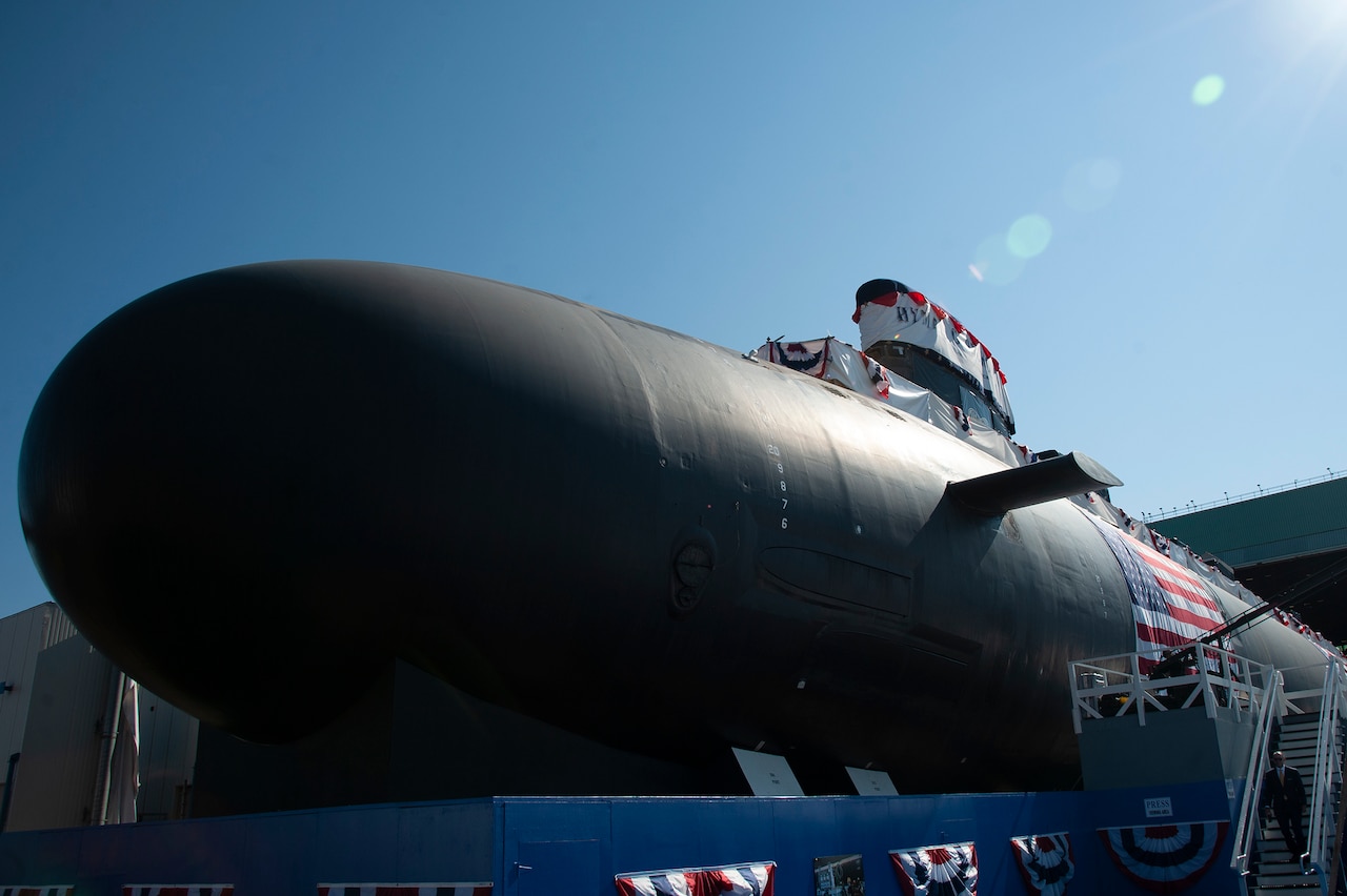 A submarine sits in a shipyard.