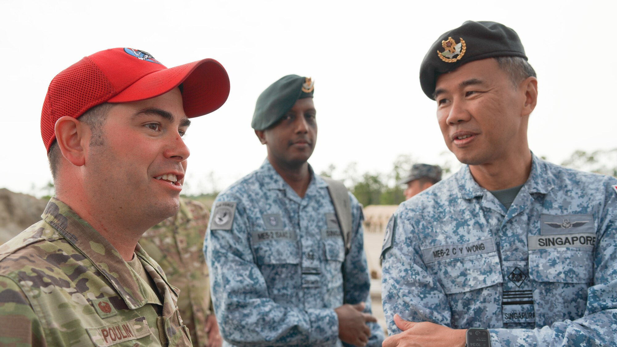 Lt. Col. Craig Poulin, 801st RED HORSE Training Squadron Commander, speaks with Singapore civil engineers, Military Expert (ME) 6 Wong Chee Yuen and ME 5 Isaac Joseph, at Readiness Challenge IX at Tyndall Air Force Base, Florida April 24-28, 2023. This year’s Readiness Challenge tested civil engineer contingency skills while operating in contested and degraded environments, strengthening their posture for the future fight. It was also an opportunity to promote multilateral cooperation and relationship-building between partner nations in attendance. (U.S. Air Force photo by HAF/A4C Strategic Communications)