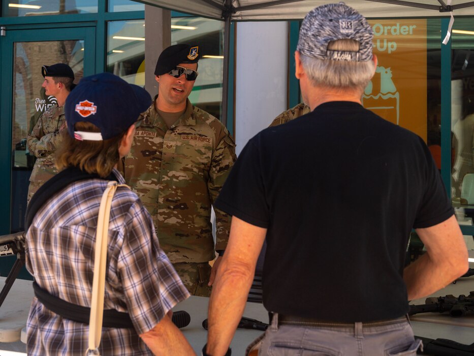 U.S. Air Force Staff Sgt. Ramon Rosa-Aponte, 56th Security Forces Squadron law enforcement patrolman, speaks with a veteran and his spouse, May 16, 2023, at Luke Air Force Base, Arizona.