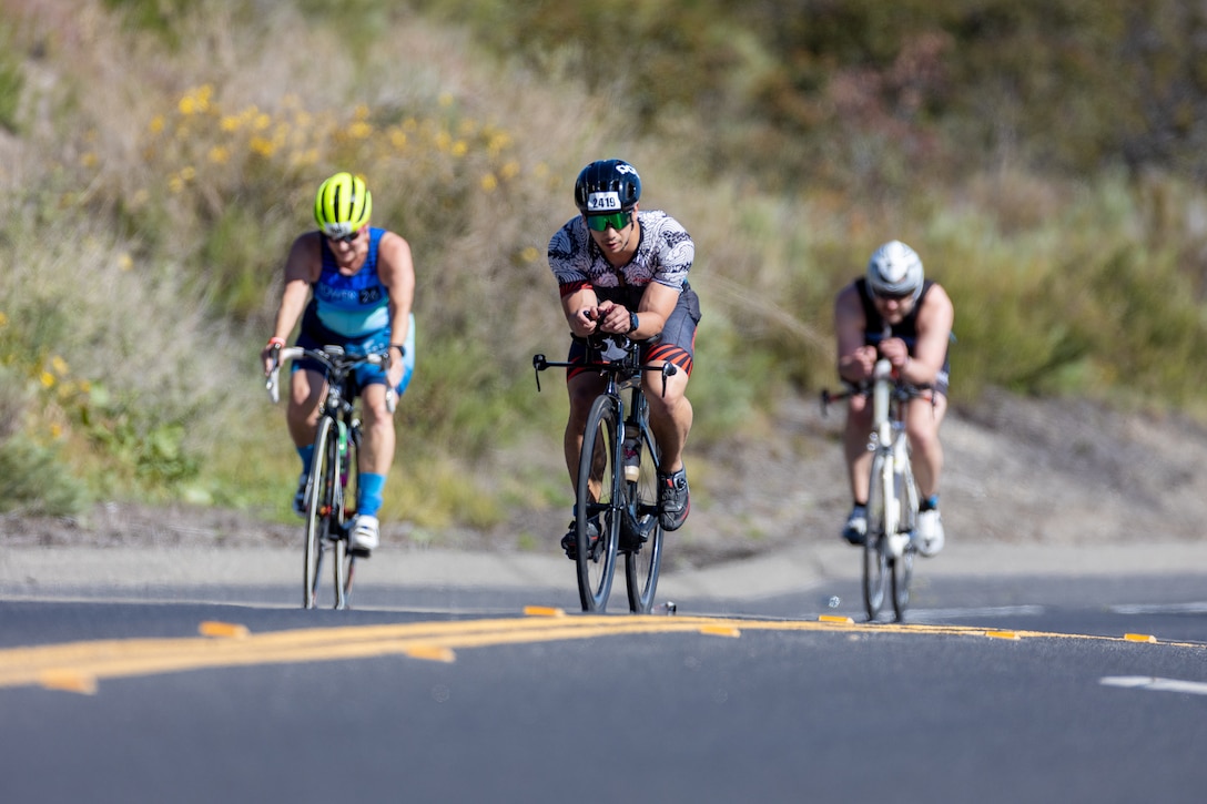 Participants compete in the cycling portion of the Ironman 70.3 Oceanside race on Marine Corps Base Camp Pendleton, California, April 1, 2023. The Ironman course consists of a 1.2-mile swim in the Oceanside Harbor, 56-mile bicycle ride through Camp Pendleton and a 13.1-mile run to the Oceanside Pier Amphitheater. (U.S. Marine Corps photo by Lance Cpl. Mhecaela J. Watts)