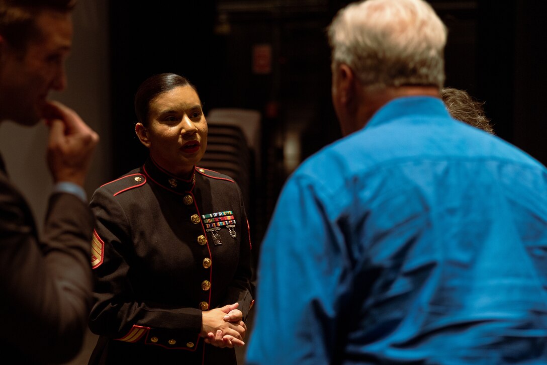 U.S. Marine Corps Staff Sgt. Laiqa Hitt, center, staff non-commissioned officer in charge and operations chief of Communication Strategy and Operations, Marine Corps Installations Pacific, speaks to an attendee after the premiere of the short documentary “Panacea” at the Oncenter, Downtown Syracuse, New York, April 23, 2023. “Panacea” is an award winning, 25-minute, short documentary directed by Hitt that follows a dancer from Syracuse City Ballet and the hardships endured through the COVID-19 pandemic. (U.S. Marine Corps photo by Lance Cpl. Thomas Sheng)