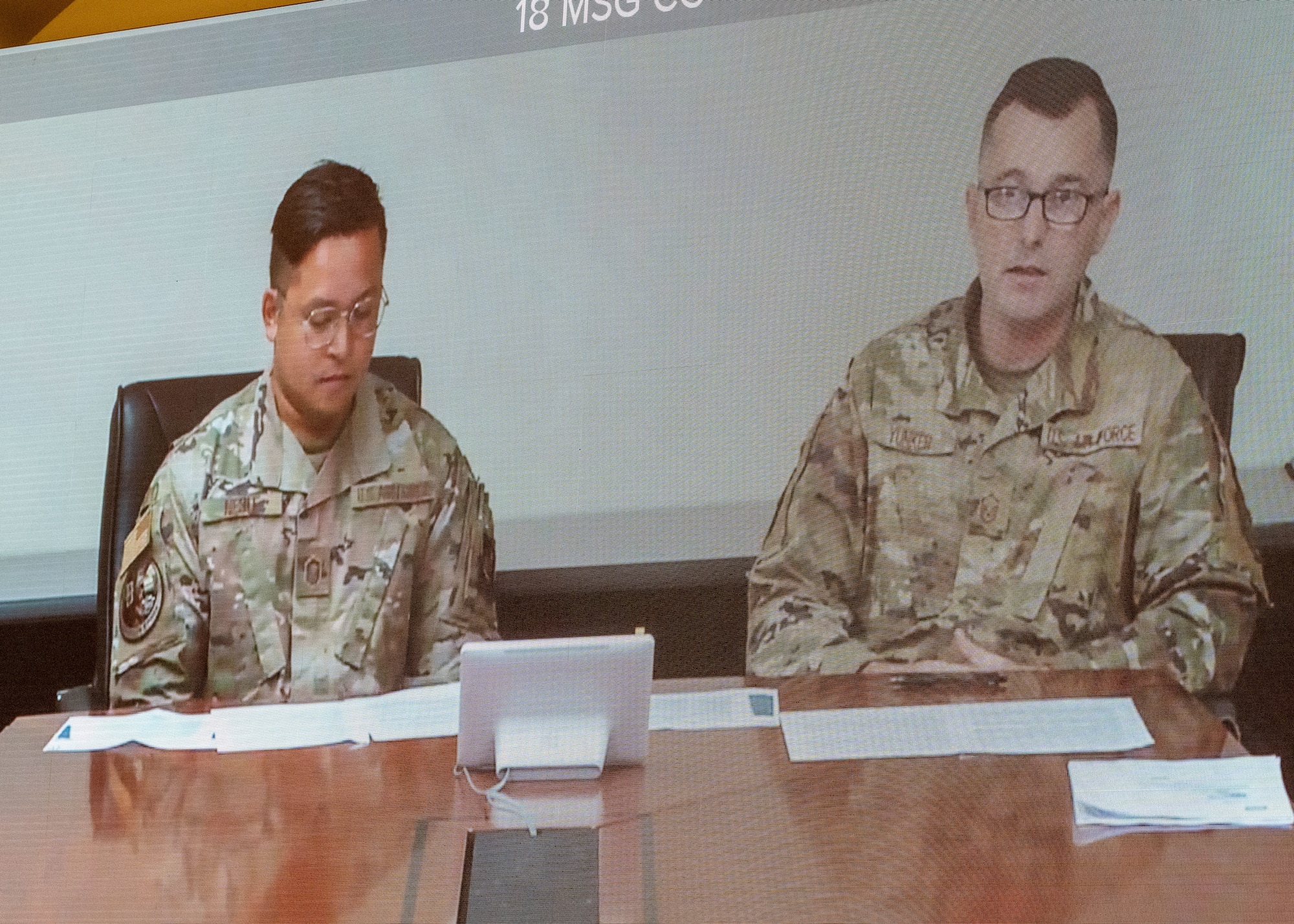 Photo of two U.S. Air Force senior non-commissioned officers answering questions through a teleconference.