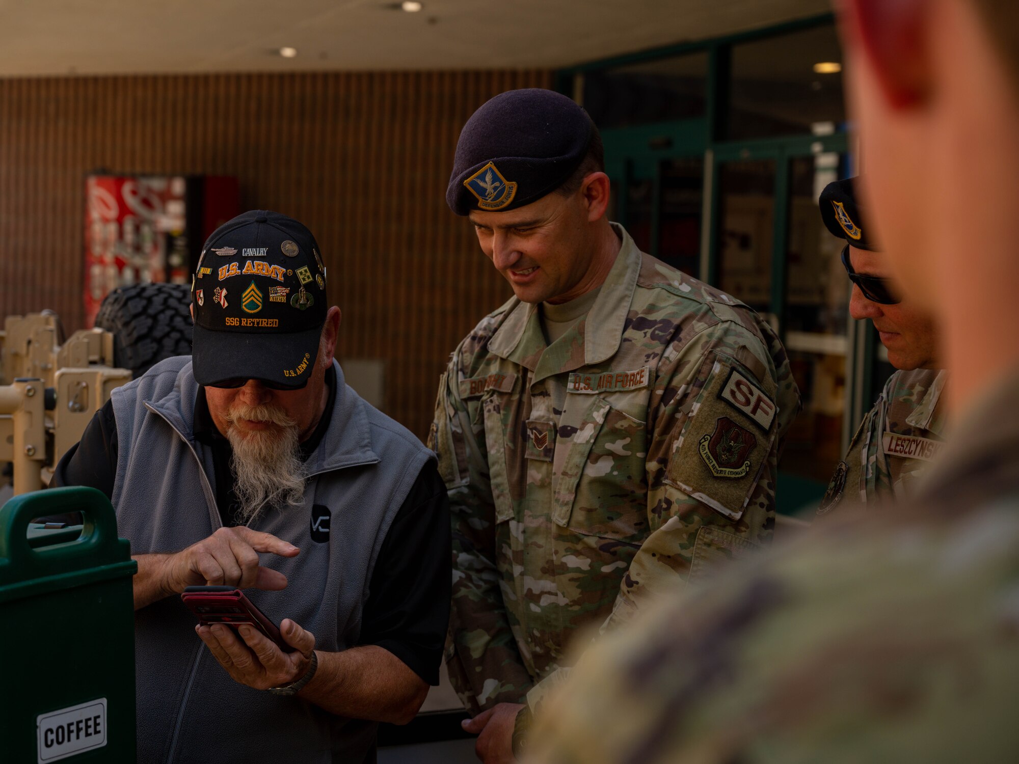A U.S. Army veteran shows U.S. Air Force Staff Sgt. Steven Boatright, 56th Security Forces Squadron combat arms instructor, photos from one of his deployments, May 16, 2023, at Luke Air Force Base, Arizona.
