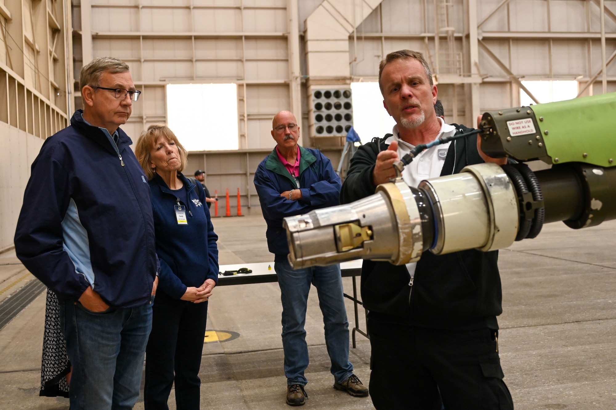 Donnie Obreiter, 97th Maintenance Squadron (MXS) director, explains a new piece of equipment on the KC-46 Pegasus boom to Air Mobility Command civic leaders at Altus Air Force Base, Oklahoma, April 27, 2023. The 97th MXS is an all-civilian workforce and makes up almost half of Altus AFB’s population. (U.S. Air Force photo by Senior Airman Kayla Christenson)