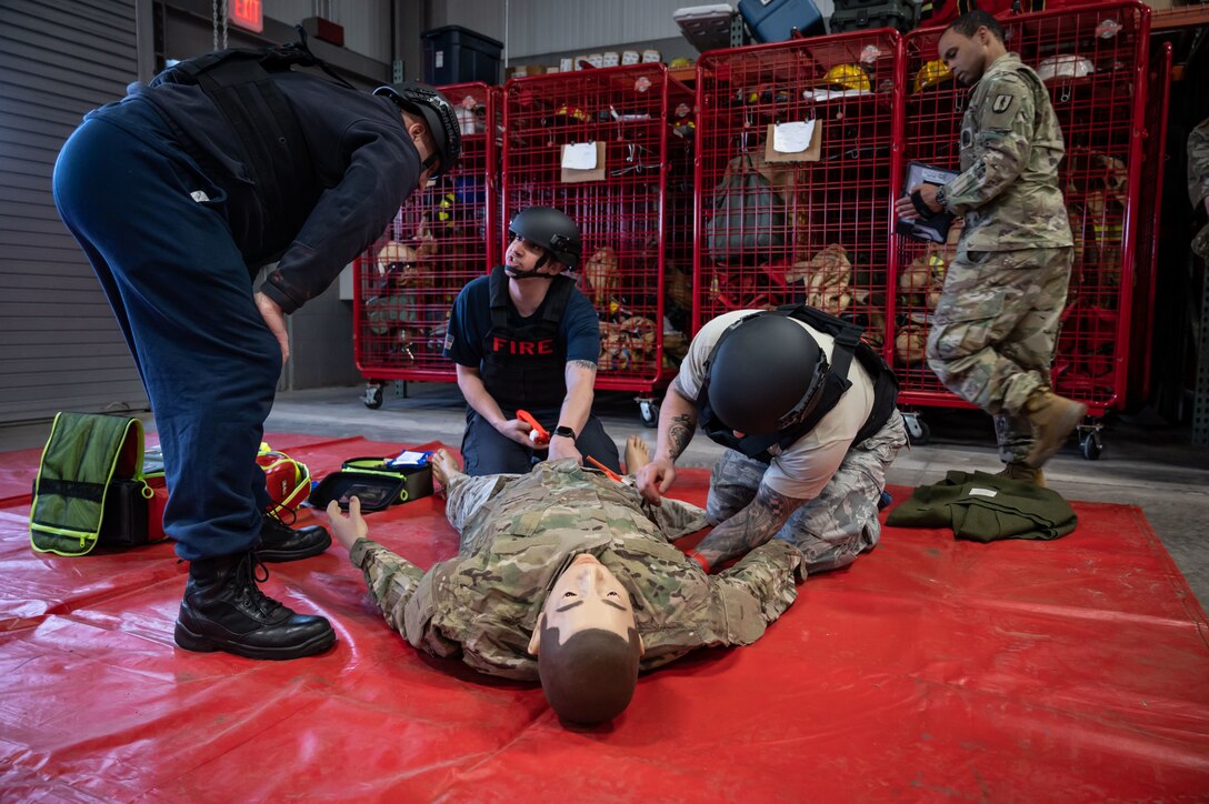 Members of the Connecticut National Guard Fire and Emergency Services, alongside 103rd Medical and Security Forces Squadrons perform Tactical Combat Casualty Care on a high fidelity training manikin at Bradley Air National Guard Base, East Granby, Connecticut, March 8, 2023. TCCC is the fundamentals of life-saving techniques developed for service members to provide trauma care in all situations.(U.S. Air National Guard photo by Master Sgt. Tamara Dabney)