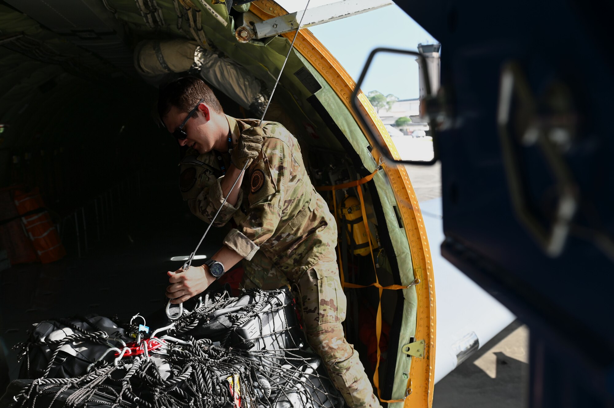 U.S. Air Force Tech. Sgt. Nicholas Sowder, 509th Weapons Squadron Advanced Instructor Training cadre and inflight refueling specialist, prepares to unload cargo using the Pack and Transport Reloader crane (PATR) prototype at Hurlburt Field, Florida, May 6, 2023. Airmen from the 509th WPS tested a new prototype PATR crane during an integration training at a special operations forces exercise at Hurlburt Field. (U.S. Air Force photo by Staff Sgt. Lawrence Sena)