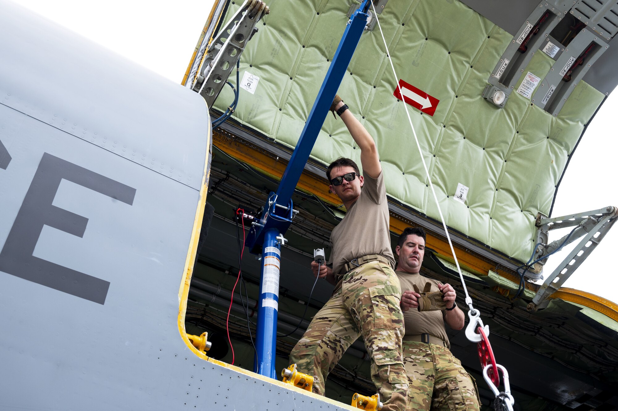 U.S. Air Force Tech. Sgt. Nicholas Sowder, 509th Weapons Squadron Advanced Instructor Training cadre and inflight refueling specialist, operates the Pack and Transport Reloader (PATR) crane prototype at Hurlburt Field, Florida, May 12, 2023. Initial testing for the crane took place at Fairchild AFB in April, and included the crane lifting multiple litters, a 250-pound Versatile Integrating Partner equipment Refueling (VIPER) refueling kit, and 300 pounds of aircraft equipment to include a tow bar. (U.S. Air Force photo by Staff Sgt. Lawrence Sena)