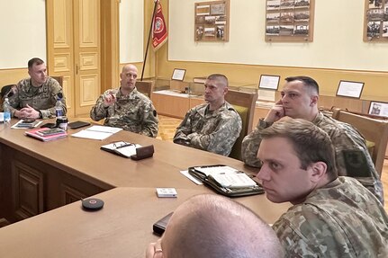 Lt. Col. Gordon Kinneer, second from left, commander, 1st Squadron, 104th Cavalry Regiment, 2nd Infantry Brigade Combat Team, and Maj. Rich Fowler, left, 1-104th Cav. executive officer, meet with soldiers from Lithuania's Uhlan Battalion May 4, 2023, in Alytus, Lithuania. (Courtesy photo)
