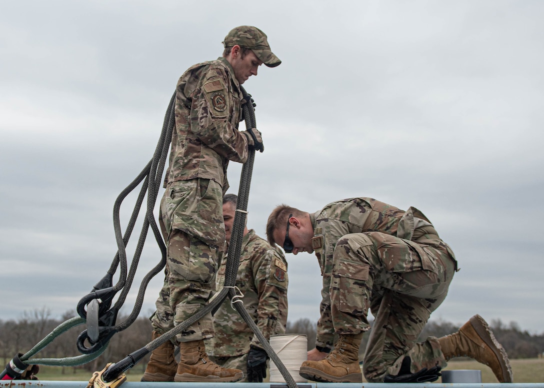 Airmen assigned to the Kentucky Air National Guard's 123rd Contingency Response Group train on hot-refueling techniques and prepare cargo for a helicopter-borne sling load carry at Boone National Guard Center in Frankfort, Ky., March 23, 2023. The training, conducted jointly with the Kentucky Army National Guard’s 63rd Theater Aviation Brigade, enhances the Air Guard unit’s ability to employ UH-60 Black Hawk helicopters in domestic and wartime environments. (U.S. Air National Guard photo by Staff Sgt. Clayton Wear)