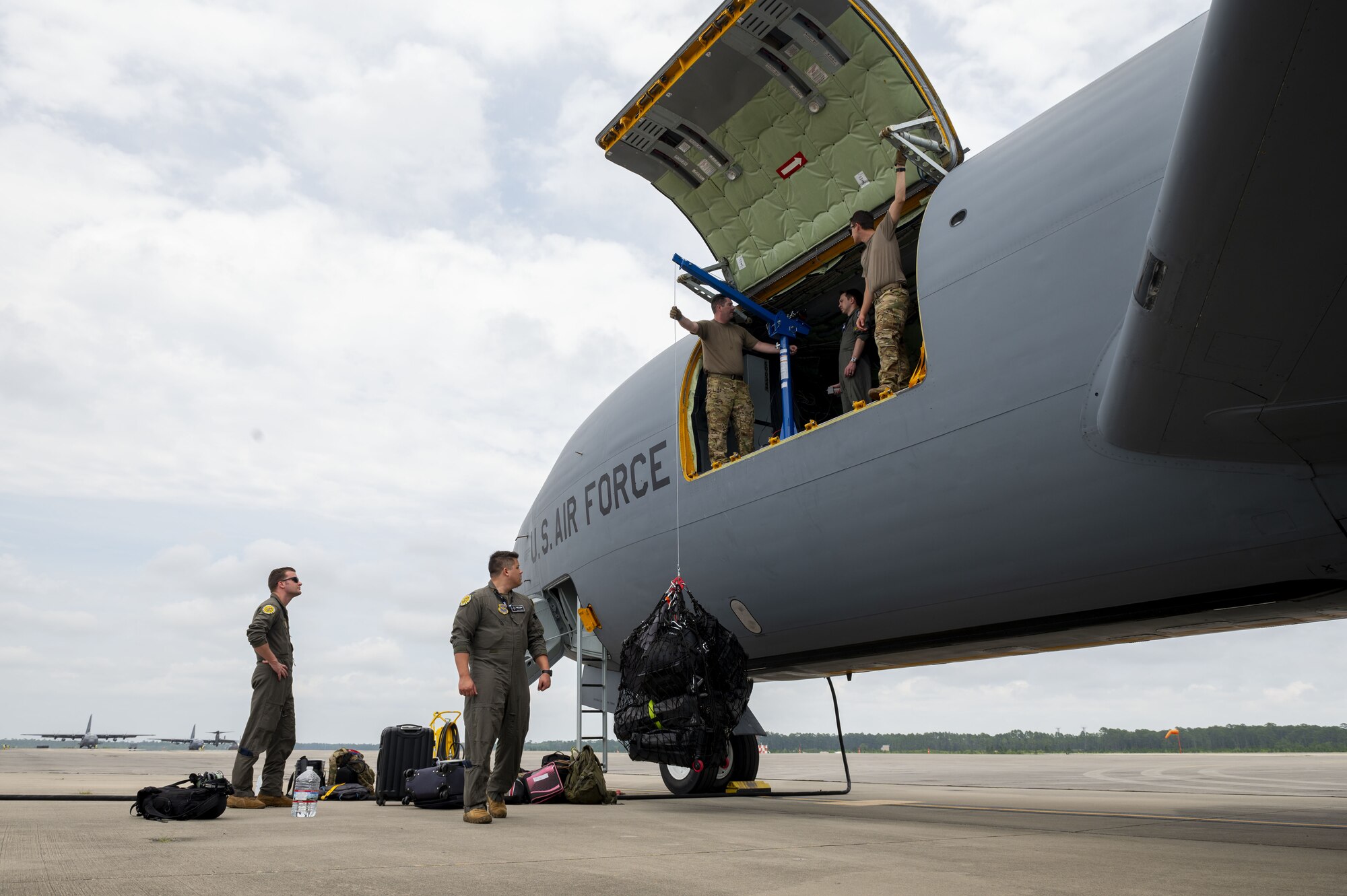 U.S. Air Force Airmen from the 509th Weapons Squadron load cargo using the Pack and Transport Reloader (PATR) crane prototype at Hurlburt Field, Florida, May 12, 2023. The 509th WPS partnered with Fairchild Air Force Base’s innovation cell to create the crane with a goal of expanding the KC-135 Stratotanker’s ability to load and unload various types of cargo using the PATR crane prototype. (U.S. Air Force photo by Staff Sgt. Lawrence Sena)