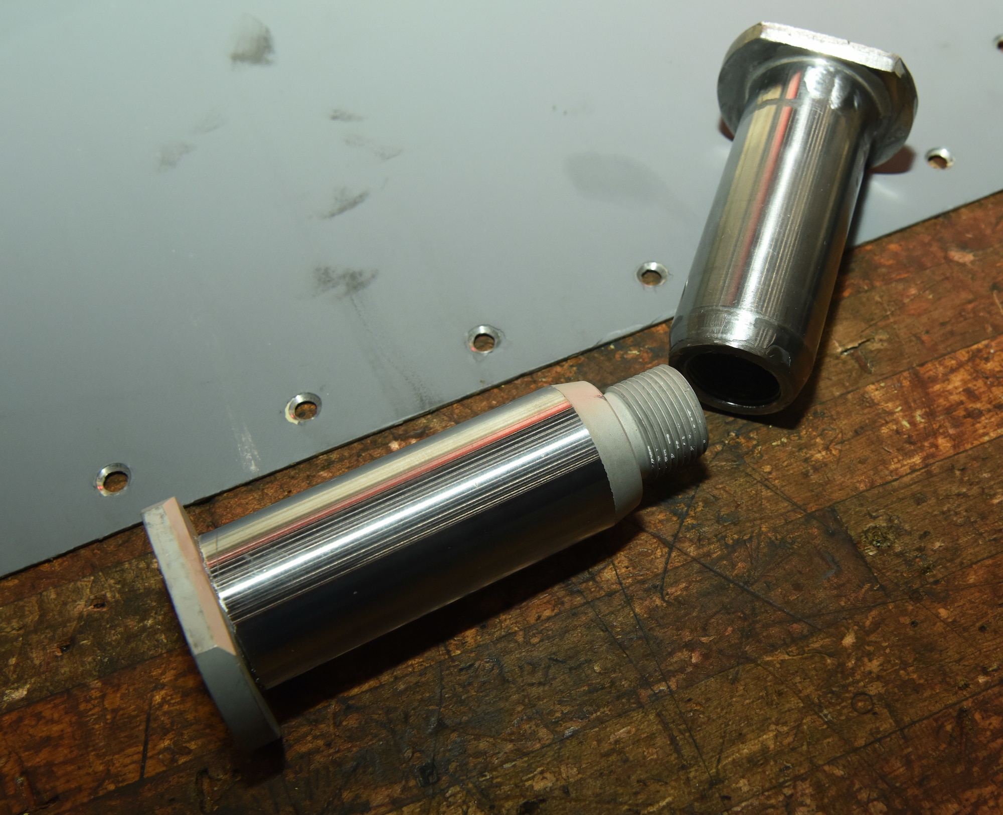 A new vertical stabilizer pin, left, lays next to a rig pin – used to physically screw on the actual pin to help position and place it correctly – before a team of Airmen from the 100th Maintenance Squadron replace the old pin on a KC-135 Stratotanker at Royal Air Force Mildenhall, England, Feb. 24, 2023. Following a Time Compliance Technical Order inspection requirement stating some vertical stabilizer pins had to be replaced due to non-conformity, a detailed inspection was conducted here. As a precautionary measure, a team from 100th MXS immediately began replacing the affected pins found on some of RAF Mildenhall’s aircraft. (U.S. Air Force photo by Karen Abeyasekere)