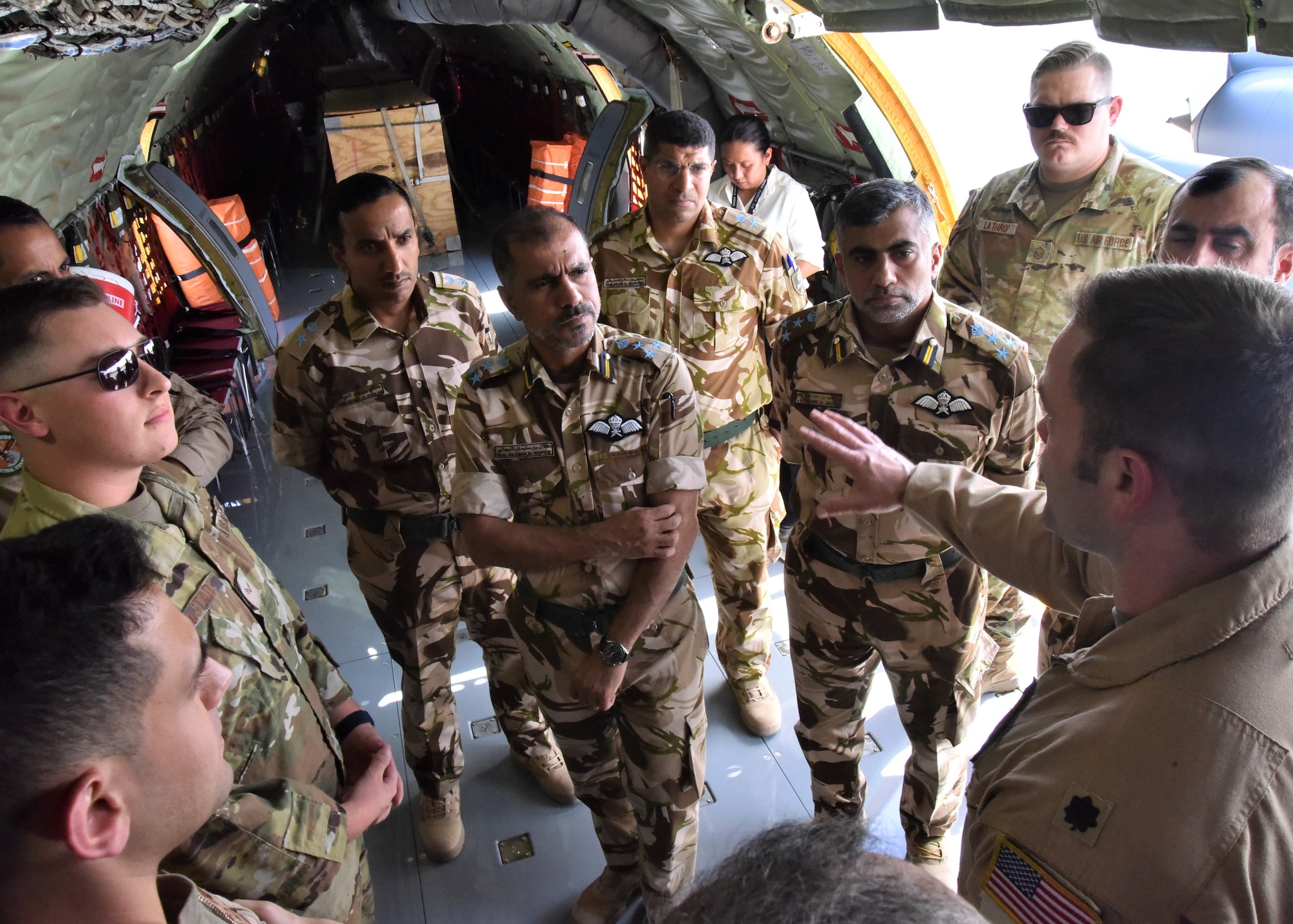 U.S. Air Force Lt. Col. Eric Wolf, 912th Expeditionary Air Refueling Squadron operations officer, discusses the KC-135R Stratotanker mission to members of the Royal Air Force of Oman during a visit May 9, 2023, at Al Udeid Air Base, Qatar. The visit served to provide ideas and recommendations to update and modernize the RAFO force and headquarters, and allowed for discussions on increased partnership opportunities for interoperability and strategic competition. (U.S. Air Force photo by Staff Sgt. Daniel Brosam)