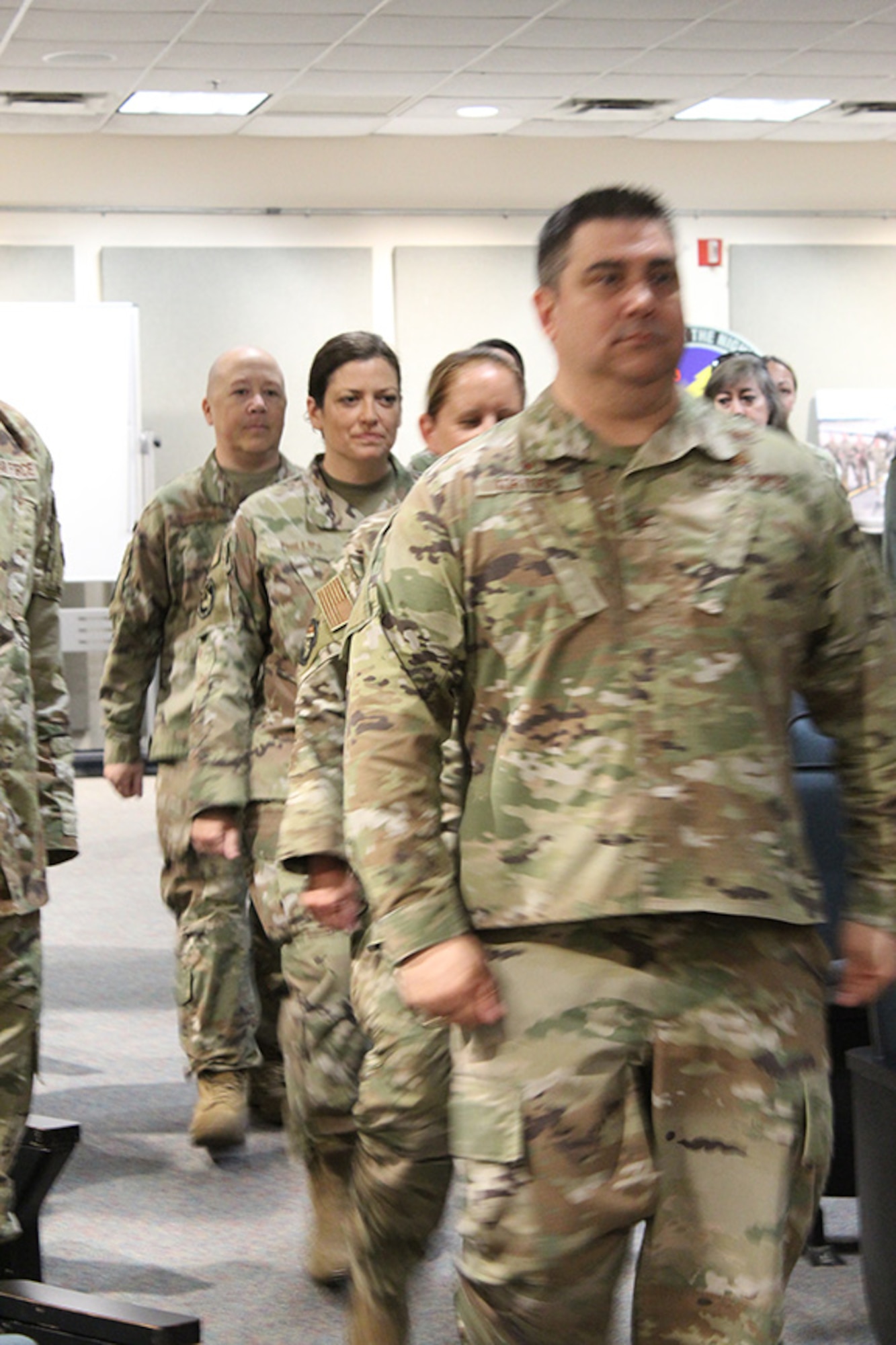 The official party, including Col. Peter Tortorici, 755th Intelligence, Surveillance and Reconnaissance Group commander, Lt. Col. Elisabeth Applegate, 28th Intelligence Squadron outgoing squadron commander, Lt. Col. Jennifer Phillips, 28 IS incoming commander and Chief Master Sgt. David Adkison, enter the auditorium for the 28 IS Change of Command ceremony May 6, 2023.
