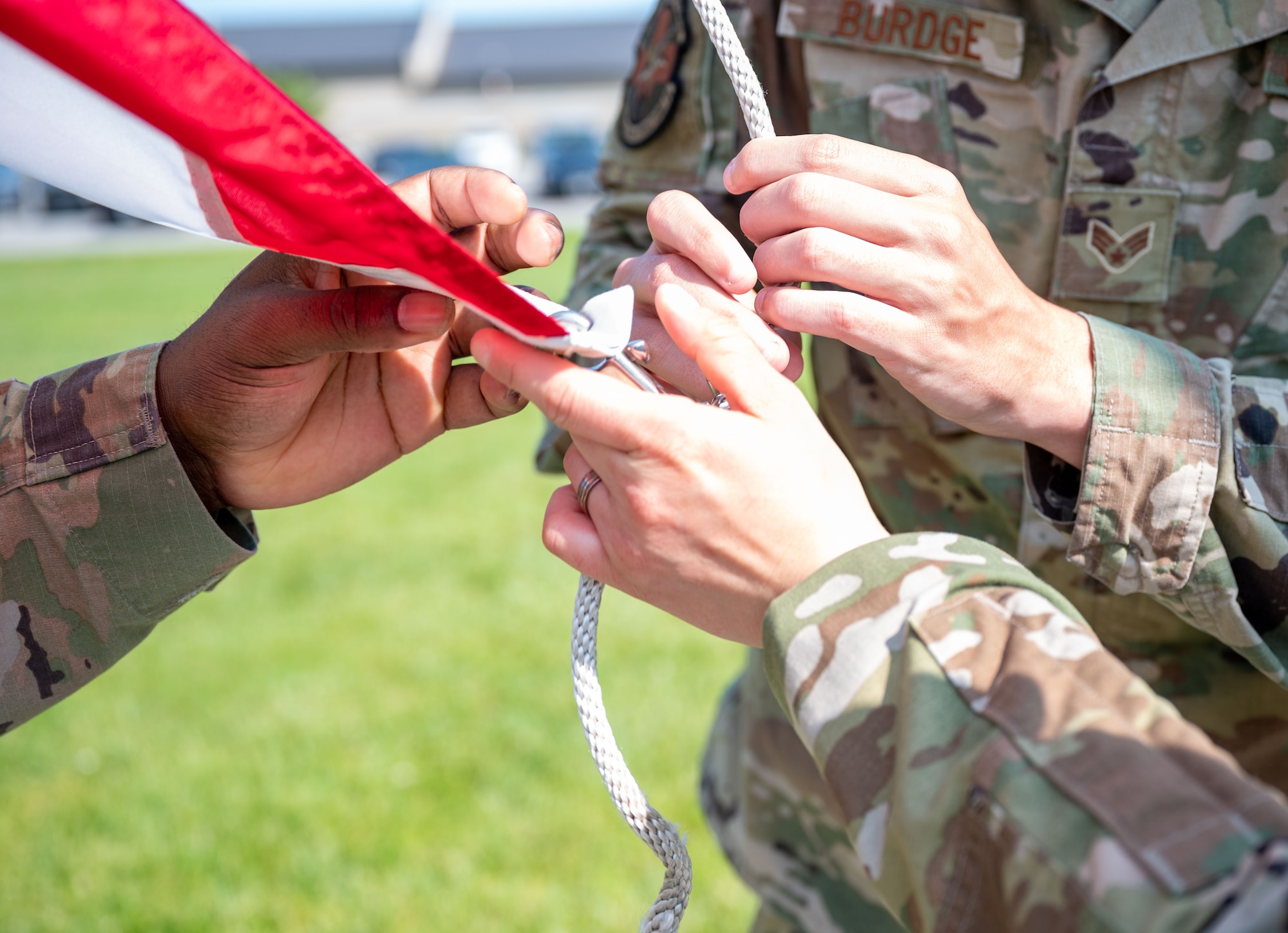 Airmen from Airman Leadership School Class 23-E unfasten the American flag during a retreat ceremony at Dover Air Force Base, Delaware, May 15, 2023. ALS Class 23-E and the 436th Mission Support Group hosted the retreat in honor of Peace Officer Memorial Day. (U.S. Air Force photo by Airman 1st Class Amanda Jett)