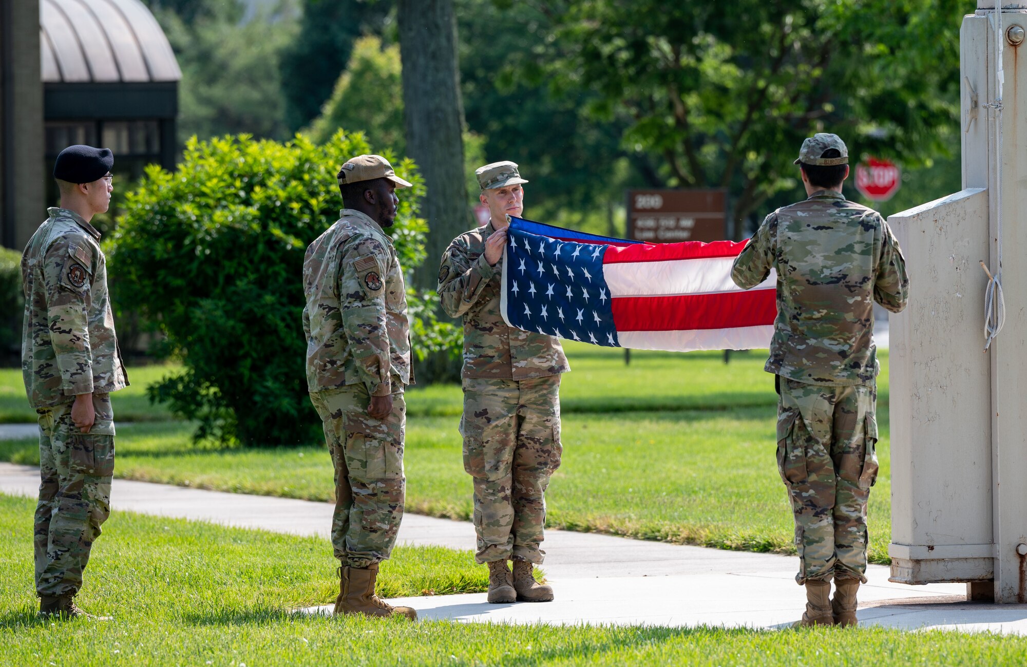 Airmen from Airman Leadership School Class 23-E fold the American flag during a retreat ceremony at Dover Air Force Base, Delaware, May 15, 2023. ALS Class 23-E and the 436th Mission Support Group hosted the retreat in honor of Peace Officer Memorial Day. (U.S. Air Force photo by Airman 1st Class Amanda Jett)