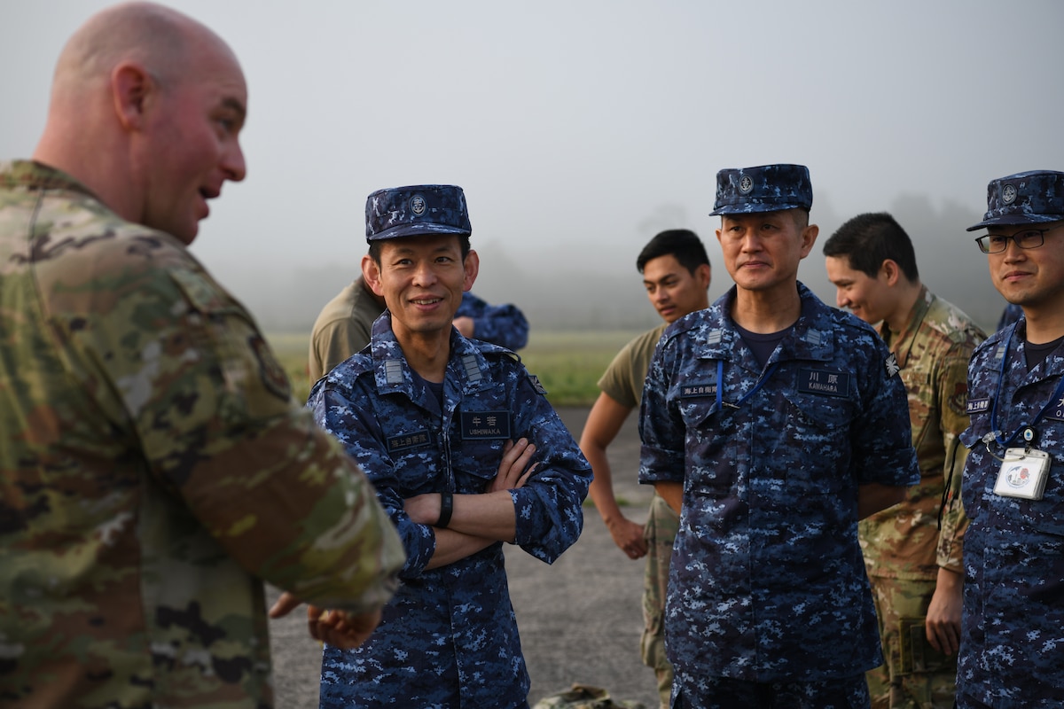 Members of the Japan Maritime Self-Defense Force listen to U.S. Air Force Master Sgt. Brent Fallon, Fifth Air Force readiness branch superintendent, as he gives instructions on how to complete a spall repair at Kanoya Air Base, Japan, May 15, 2023. Spall repairs are an efficient way to keep airfields serviceable by removing and replacing damaged parts of concrete slabs. (U.S. Air Force photo by Staff Sgt. Spencer Tobler)