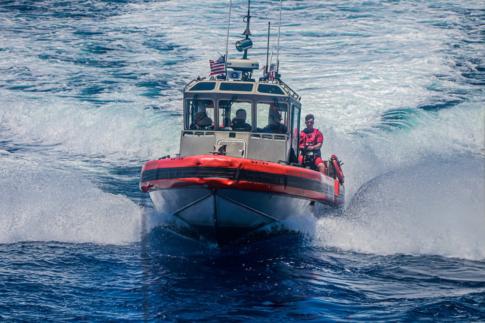 A Coast Guard Cutter Hamilton small boat boatcrew transports six migrants who were stranded on Cay Sal Island, Bahamas to Coast Guard Cutter Hamilton, May 9, 2023.  (U.S. Coast Guard courtesy photo)