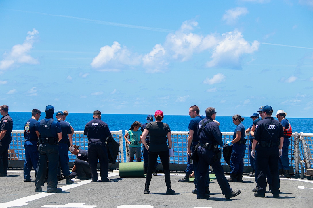 Six migrants arrive on Coast Guard Cutter Hamilton May 9, 2023 off the coast of Cay Sal Island, Bahamas. The migrants were rescued by the Coast Guard after they became stranded on Cay Sal Island, Bahamas. (U.S. Coast Guard courtesy photo)
