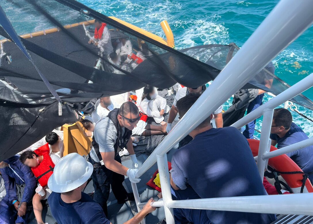 Coast Guard Cutter Manowar crew care for migrants aboard the vessel, May 12, 2023.