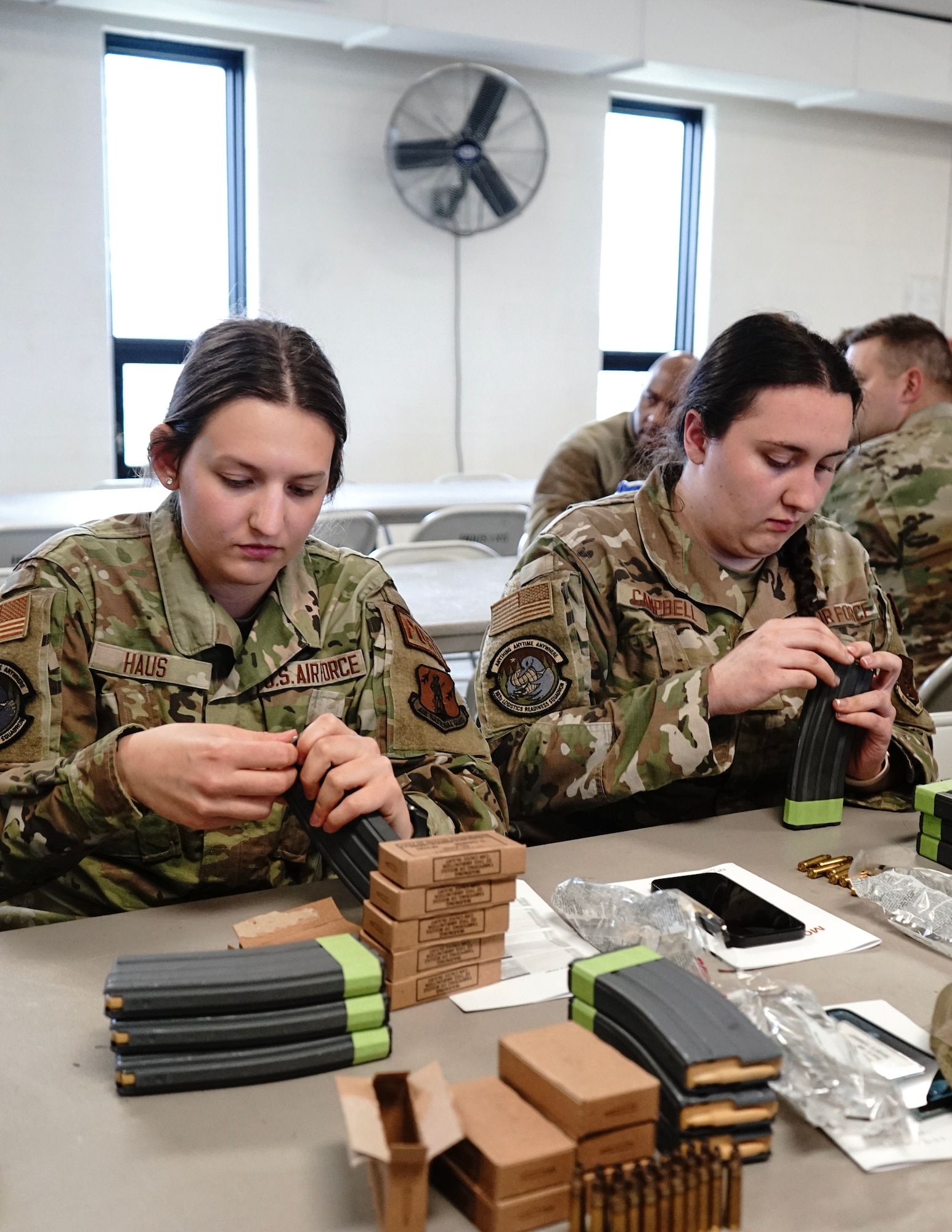 U.S. Air Force Airman 1st Class Alycia Haus, left, and Staff Sgt. Hannah Campell, right, 133rd Logistics Readiness Squadron, loads magazines with 5.56 ammo at Camp Ripley, Little Falls, Minn., May 6, 2023.