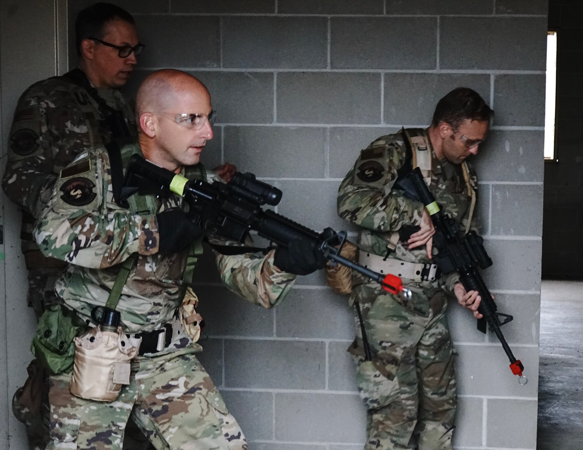 U.S. Air Force Chief Master Sgt. Earl Merchlewitz, left, Senior Master Sgt. Jeffery Leuwerke, center, and Lt. Col. Jason Bartlett, 133rd Logistics Readiness Squadron, participate in building clearing exercises at Camp Ripley, Little Falls, Minn., May 7, 2023.