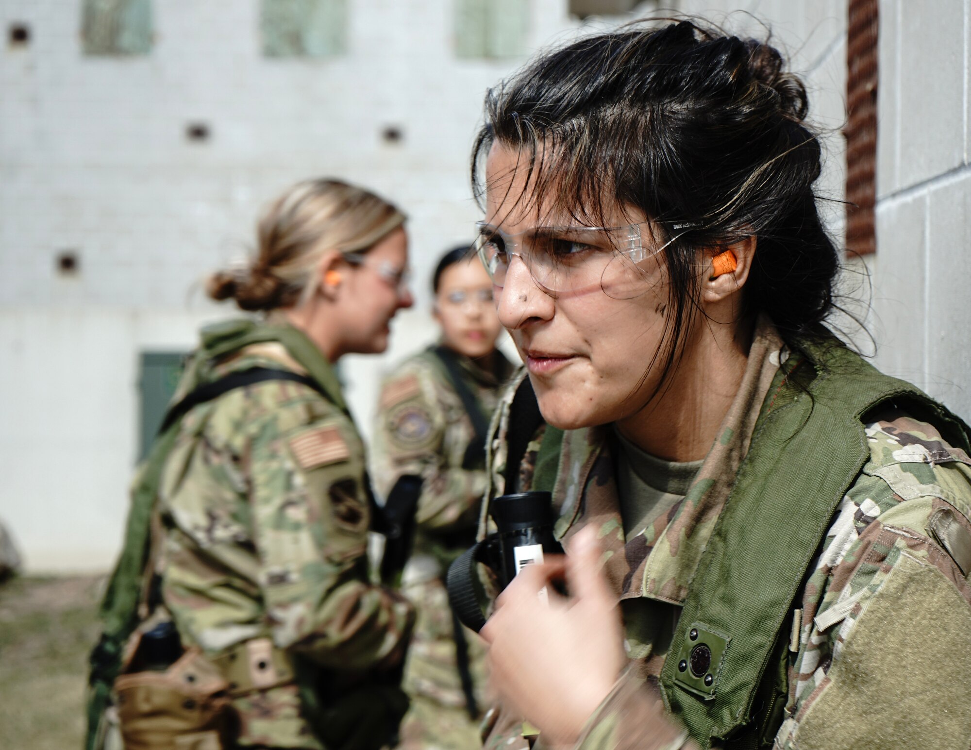 U.S. Air Force Tech. Sgt. Marissa Ricci, 133rd Air Transportation Function, prepares to enter a building at Camp Ripley, Little Falls, Minn., May 7, 2023.