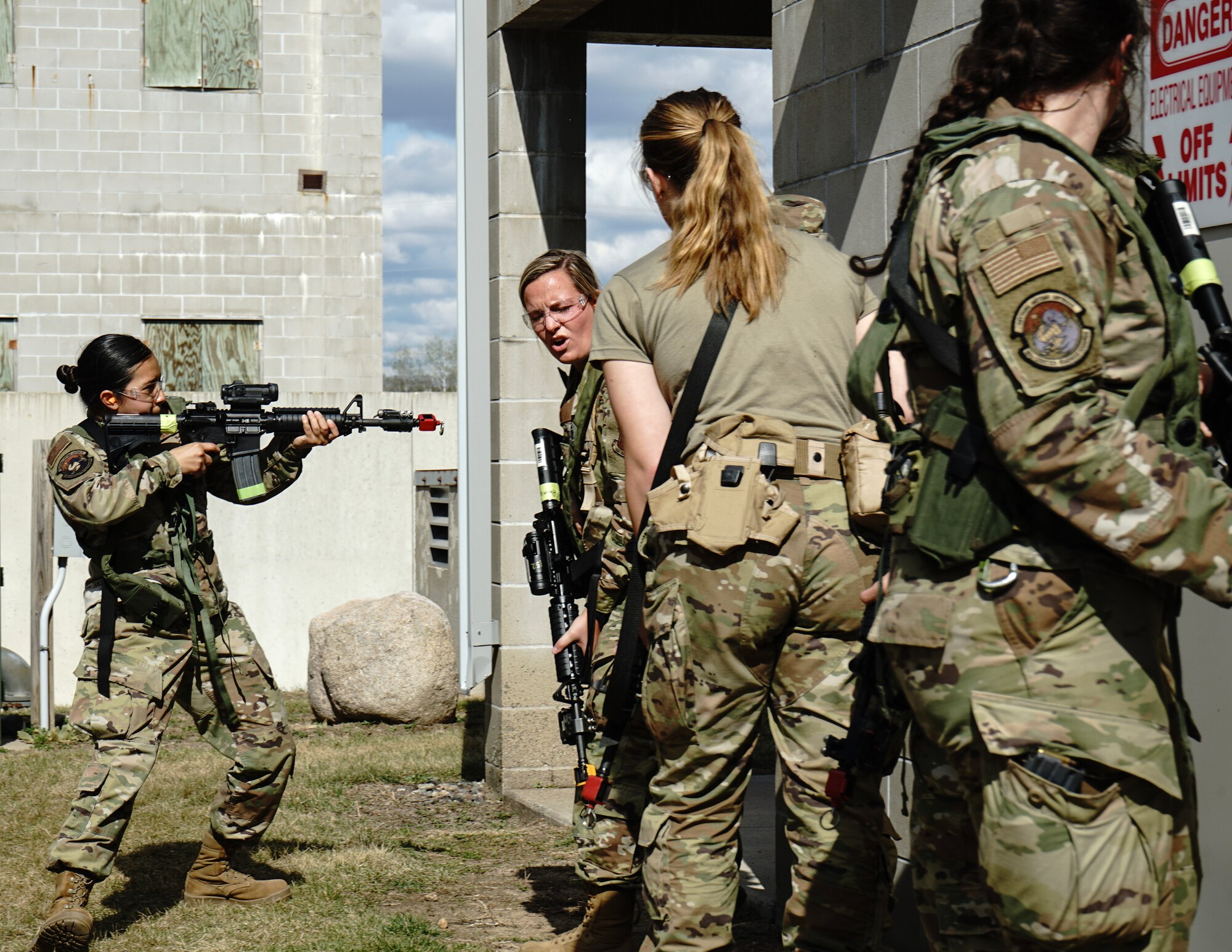 U.S. Air Force Airmen from the 210th Engineering Installation Squadron and 133rd Logistics Readiness Squadron prepare to enter a building at Camp Ripley, Little Falls, Minn., May 7, 2023.