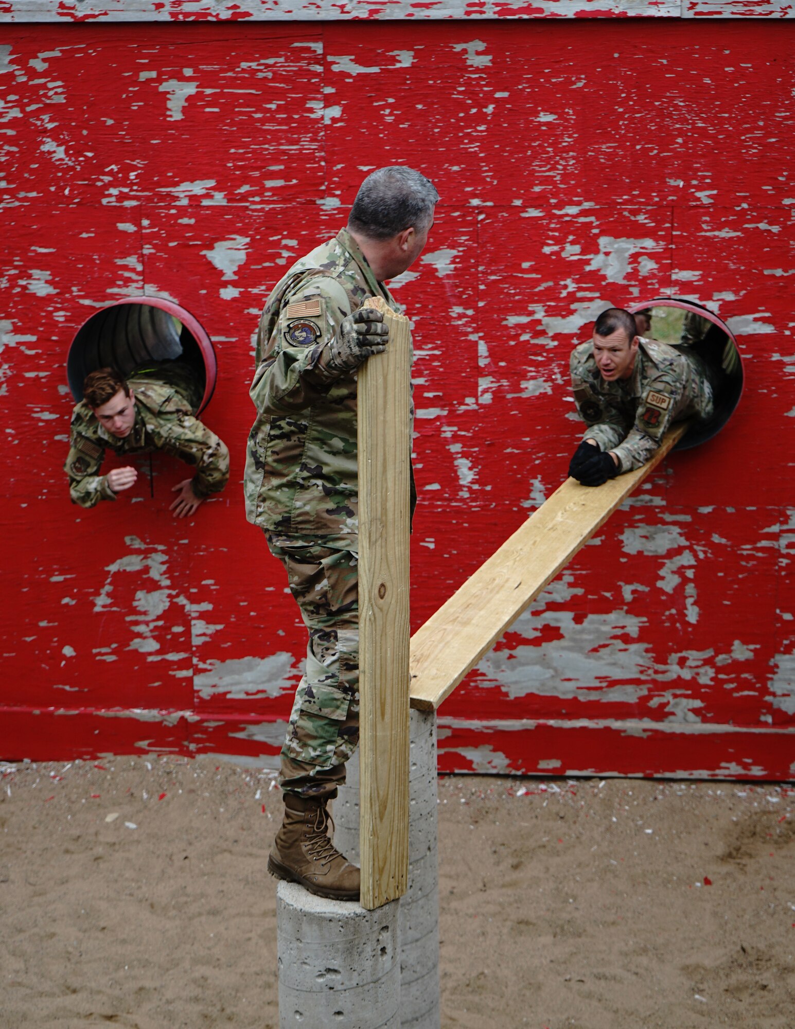 U.S. Air Force Airman 1st Class Braydon Burds, left, Master Sgt. Rory Canniff, right, and Master Sgt. Brian Prestegaard, center, 133rd Logistics Readiness Squadron, participate in team building activities at Camp Ripley, Little Falls, Minn., May 8, 2023.