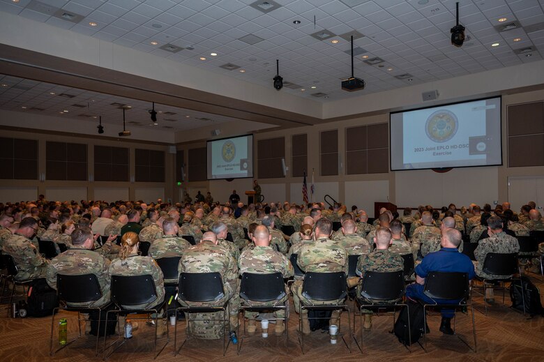 members in uniform gather for a conference.