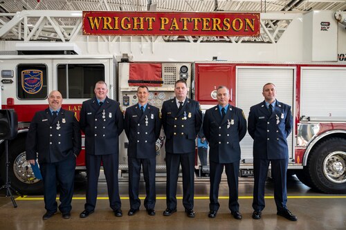 Six Wright-Patterson firefighters pose for a photograph in front of a fire truck.