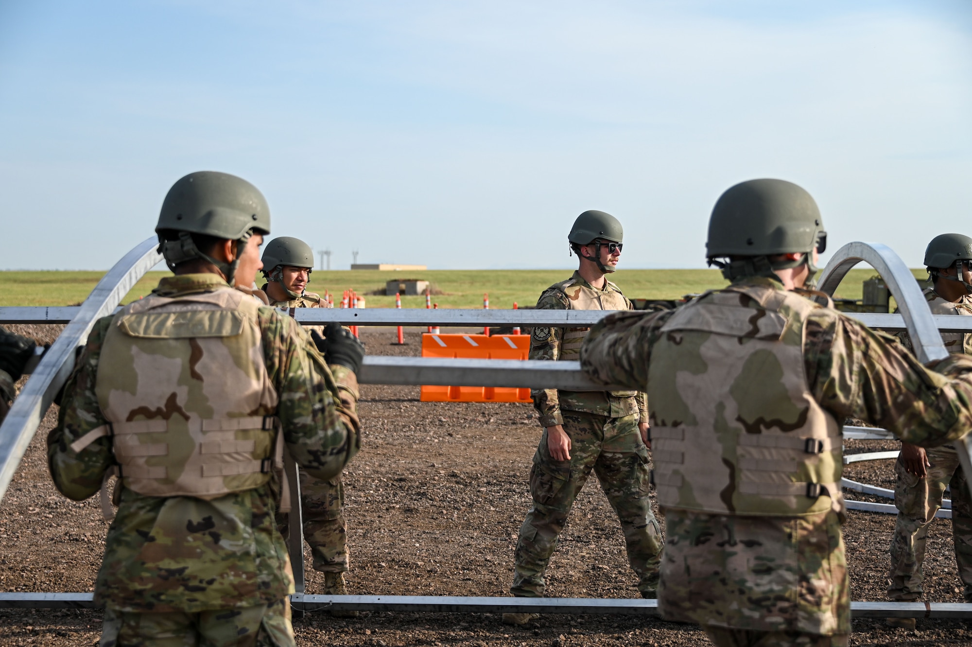 Airmen from the 97th Civil Engineer Squadron gather tools to build a tent during a deployment exercise at Altus Air Force Base, Oklahoma, May 10, 2023. The deployment exercise included building multiple tents in various ways. (U.S. Air Force photo by Senior Airman Kayla Christenson)