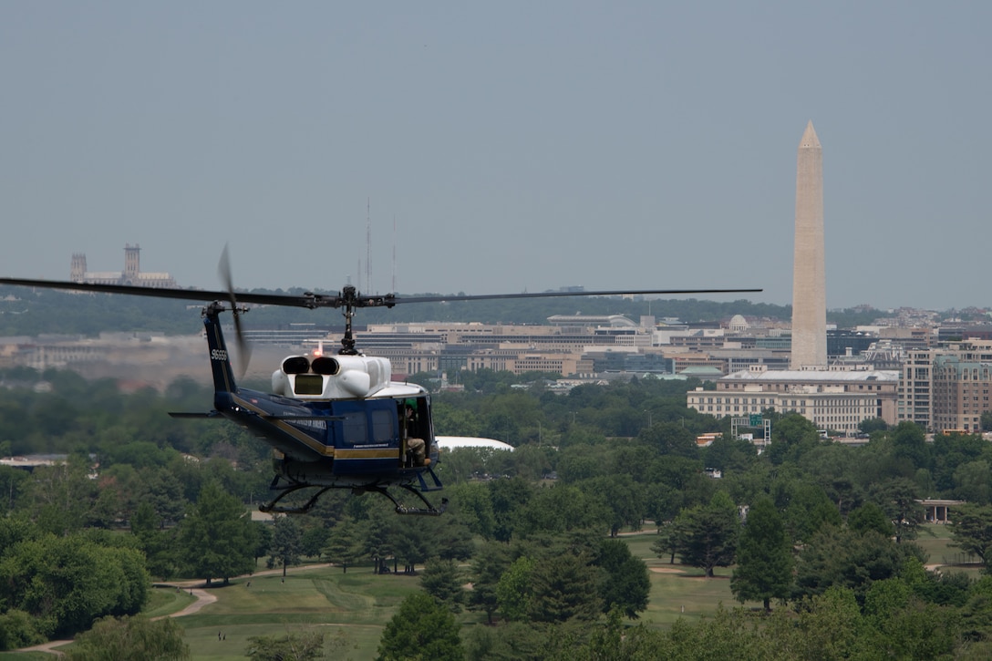 A UH-1N Huey helicopter from the 1st Helicopter squadron flies over the National Mall in Washington D.C., May 13, 2023. This fly-over was part of the Vietnam Veterans' "Welcome Home" Ceremony celebrating Vietnam veterans for their service. (U.S. Air Force photo by Senior Airman Daekwon Stith)