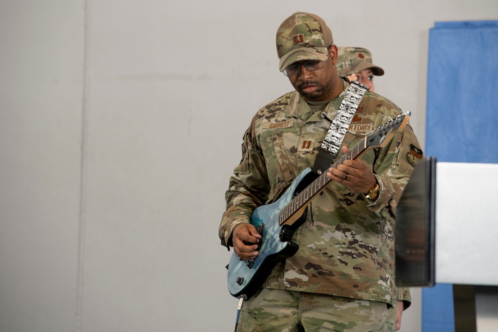 Man in uniform playing electric guitar