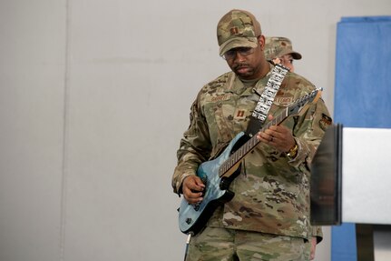 Man in uniform playing electric guitar