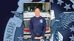 Woman stands in front of an emergency vehicle