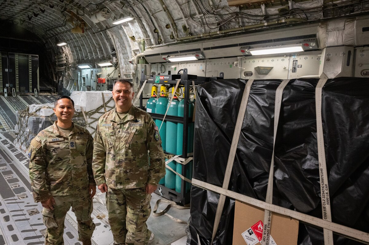 Chief Master Sgt. Leomel I. Abueg, U.S. Space Force-Indo-Pacific Component-Field Command Senior Enlisted Leader, left, and Brig. Gen. Anthony Mastalir, U.S. Space Force-Indo-Pacific commander, take a photo in front of the second of two Space Domain Awareness sensors that will be delivered to Japan, while the bundle is in transit at Joint Base Pearl Harbor-Hickam, Hawaii, May 9, 2023. U.S. Forces Japan and U.S. Space Forces Indo-Pacific continue to make significant strides in Japan since activating the new service component in November 2022. (U.S. Air Force photo by Tech. Sgt. Hailey Haux)