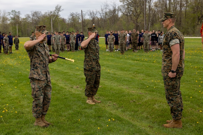 U.S. Marine Corps SgtMaj. Luis A. Galvez, outgoing Sergeant Major, passes his duties as Sergeant Major of Recruiting Station Milwaukee, 9th Marine Corps District, to SgtMaj. Anthony E. Stockman, during a Post and Relief ceremony at Ft. McCoy, Wisconsin, May 13, 2023. The post and relief ceremony serves as the official changeover between Sergeants Major, honoring the outgoing SgtMaj's contributions to the unit while offering the opportunity for the oncoming SgtMaj to introduce himself to the Marines now under their charge. (U.S. Marine Corps photo by Sgt Ethan M. LeBlanc)