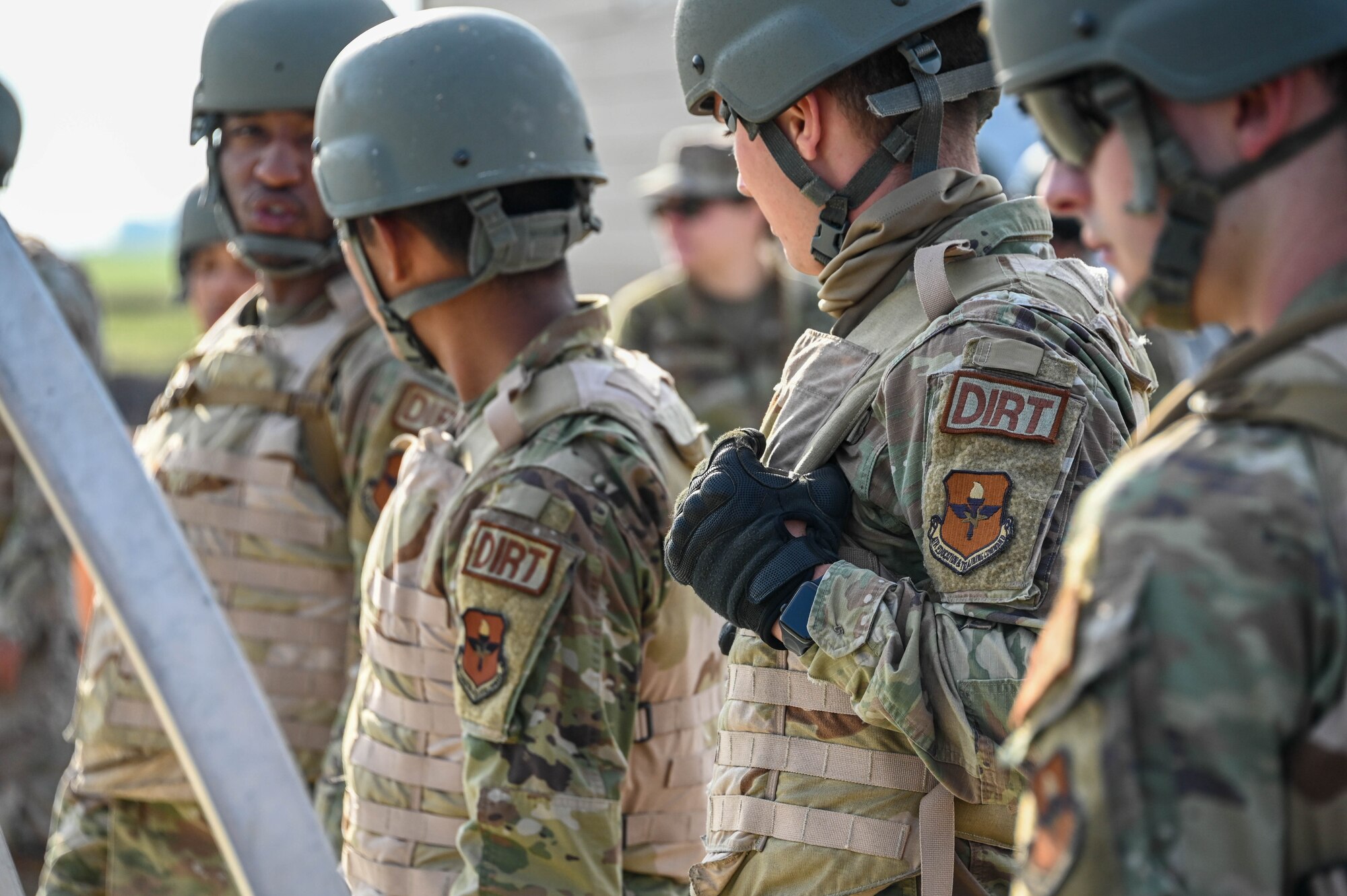 Airmen from the 97th Civil Engineering Squadron wait for instructions while building a tent at Altus Air Force Base (AFB), Oklahoma, May 10, 2023. More than 20 Airmen are a part of ‘Dirt Boyz’, a flight that completes various tasks at Altus AFB and deployed to keep the base operating and up to date. (U.S. Air Force photo by Senior Airman Kayla Christenson)