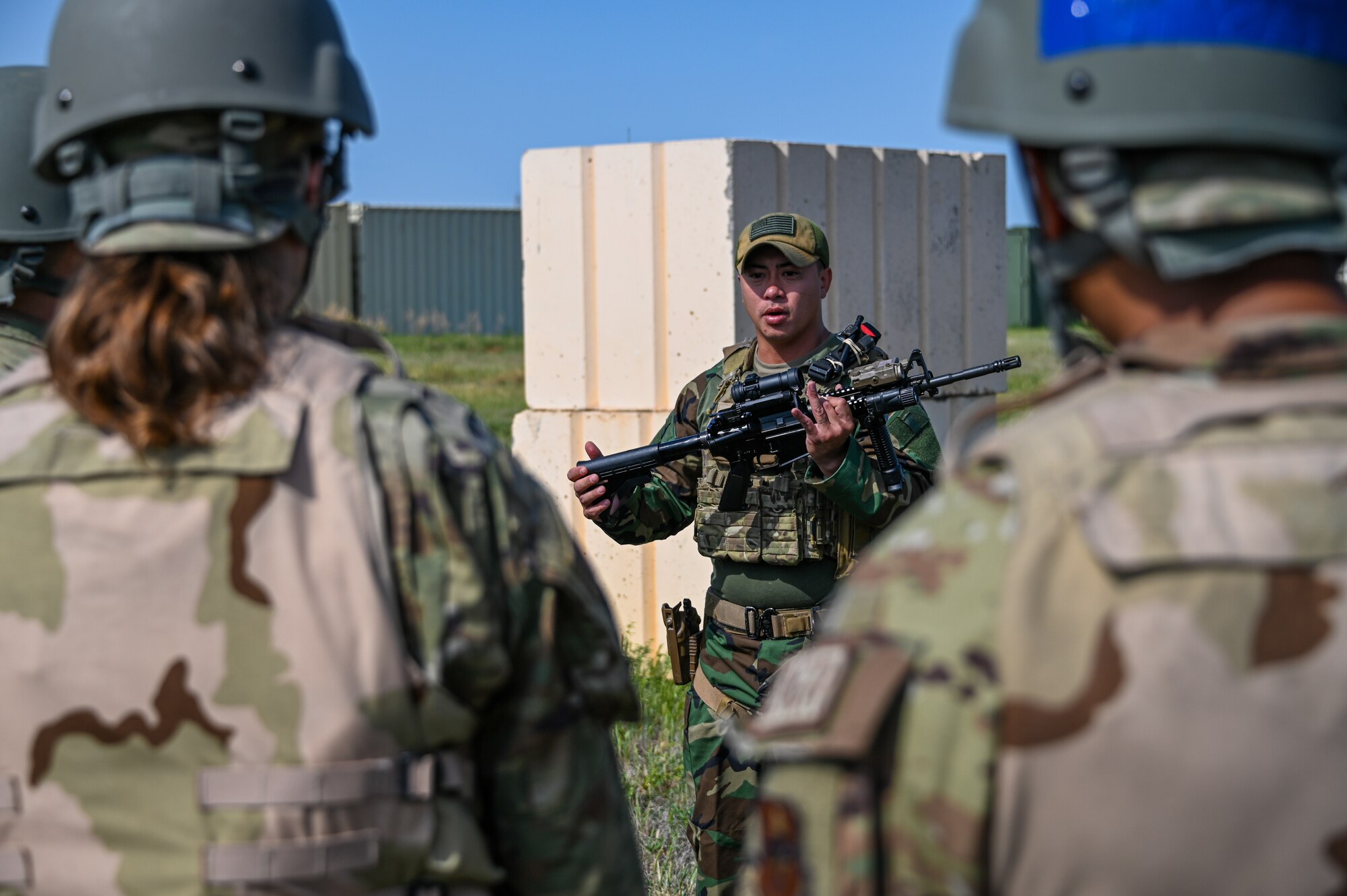 U.S. Air Force Master Sgt. James Ta, 97th Security Forces Squadron section chief of training and standardization, teaches Airmen from the 97th Civil Engineering Squadron about the M4 rifle at Altus Air Force Base, Oklahoma, May 10, 2023. The M4 rifle is used as a foundational learning weapon for Airmen when completing weapons training. (U.S. Air Force photo by Senior Airman Kayla Christenson)
