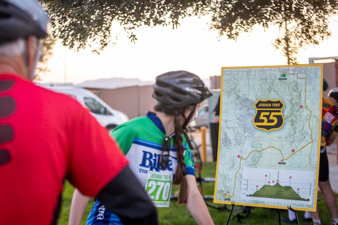 A bicyclist reviews a map of the race route