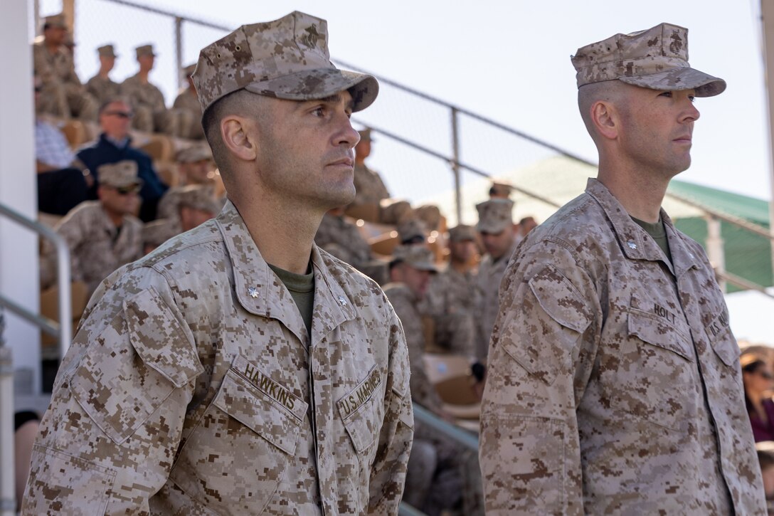 U.S. Marine Corps Lt. Col. Matthew Hawkins, oncoming commanding officer for 3rd Battalion, 7th Marine Regiment, left, and Lt. Col. Tyler Holt, outgoing commanding officer, stand at attention for a pass and review, during a 3rd battalion, 7th Marine Regiment change of command ceremony at Marine Corps Air Ground Combat Center, Twentynine Palms, California, May 5, 2023. The ceremony represented a transfer of responsibility, authority, and accountability from Holt to Hawkins. (U.S. Marine Corps photo by Cpl. Breanna Eason)