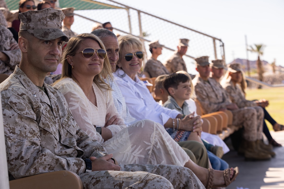 U.S. Marine Corps Lt. Col. Matthew Hawkins, oncoming commanding officer for 3rd Battalion, 7th Marine Regiment, sits with his family during a 3rd battalion, 7th Marine Regiment change of command ceremony at Marine Corps Air Ground Combat Center, Twentynine Palms, California, May 5, 2023. The ceremony represented a transfer of responsibility, authority, and accountability from Lt. Col. Tyler Holt to Hawkins. (U.S. Marine Corps photo by Cpl. Breanna Eason)