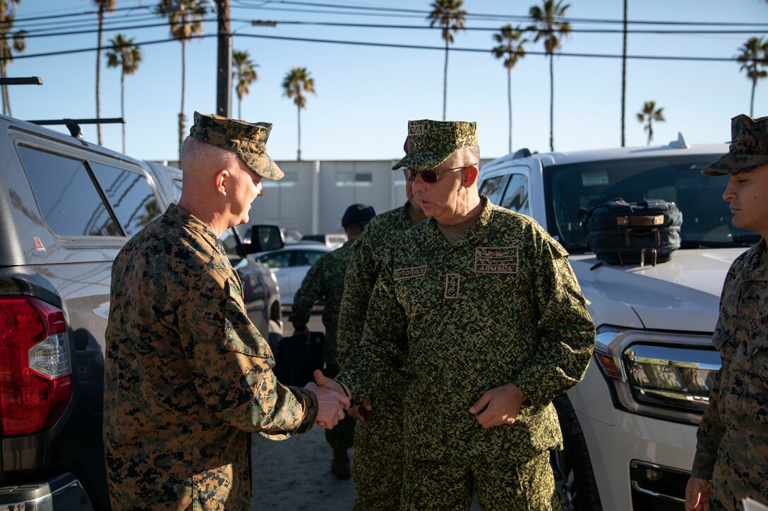 U.S. Marine Corps, Brig. Gen. Ryan Rideout, left, the I Marine Expeditionary Force deputy commanding general, presents a coin to Brig. Gen. Jorge Torres, right, commandant of the Colombian Marine Corps, during a visit to Marine Corps Base Camp Pendleton, California, Feb. 15, 2023. The visit is designed to reinforce strategic relationships between senior Colombian military and senior Marine Corps leadership. During the visit, Marine Corps leaders briefed senior Colombian leadership about tactical concepts and general strategy. (U.S. Marine Corps photo by Sgt. Nello Miele)