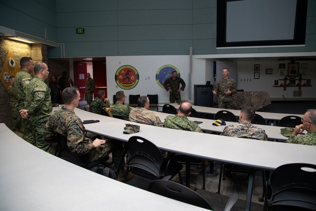 U.S. Marine Corps Capt. Jon Schumann, center, an infantry officer with advanced infantry training battalion School of Infantry - West briefs Colombian military leadership during a visit to Marine Corps Base Camp Pendleton, California, Feb. 15, 2023. The visit is designed to reinforce strategic relationships between senior Colombian military and senior Marine Corps leadership. During the visit, Marine Corps leaders briefed senior Colombian leadership about tactical concepts and general strategy. (U.S. Marine Corps photo by Sgt. Nello Miele)