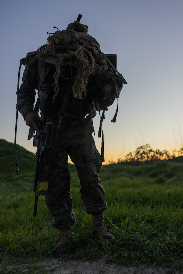 A U.S. Marine with Infantry Marine Course 1-23, Infantry Training Battalion, School of Infantry - West, adjusts his pack while hiking during the course’s final training exercise on Marine Corps Base Camp Pendleton, California, Jan. 27, 2023. IMC is the Marine Corps’ 14-week entry-level training course for enlisted infantry Marines. (U.S. Marine Corps photo by Lance Cpl. Earik Barton)